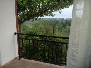 a balcony with a view of a tree at Ananthaya -the infinity in Kalutara
