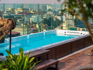 a swimming pool with a view of a city at Peridot Gallery Classic Hotel in Hanoi