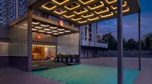 a building with a pool in front of it at Ginger Ahmedabad Changodar in Kāsandra