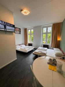 Großes Zimmer mit 2 Betten und einem Tisch in der Unterkunft Stadtoase im Herzen Berlins in Berlin