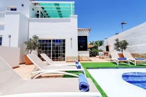 a villa with a swimming pool and a house at Casa Tauro in Adeje