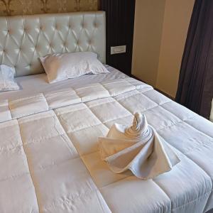 Ένα ή περισσότερα κρεβάτια σε δωμάτιο στο HOTEL RAMSON'S INTERNATIONAL