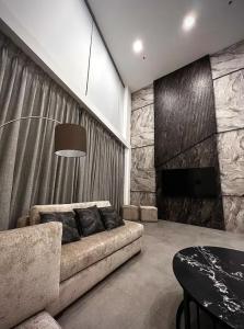 a living room with a couch and a fireplace at Luxury Apartments - Damac Tower Amman in Amman