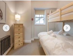 a bedroom with a bunk bed and a dresser at Ferrymans Rest in Dartmouth