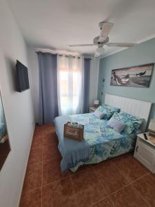 a bedroom with a bed with a bag on it at BAHIA AZUL in Caleta De Fuste