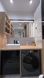 a kitchen with a dishwasher and a counter top at Apartament Poleska in Częstochowa