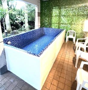 a large blue bath tub sitting on a patio at 雨でも炭でBBQが出来る/プール付き!MAX12名/駐車2台可能! in Shirahama