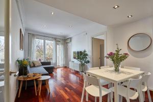 a living room with a table and a couch at BBarcelona Gracia Flat in Barcelona