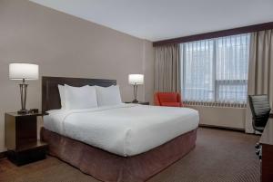 Postel nebo postele na pokoji v ubytování Ramada Plaza by Wyndham Calgary Downtown