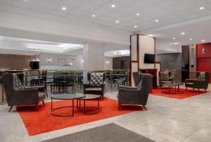 a lobby with a bar with chairs and a table at Ramada Plaza by Wyndham Calgary Downtown in Calgary