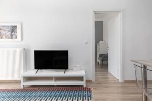 Televízia a/alebo spoločenská miestnosť v ubytovaní Liberty Apt by halu! Apartments