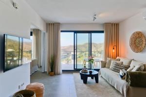 a living room with a couch and a table at Casa Grace in Nerja +23 photos