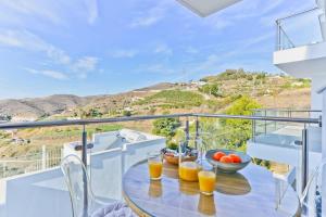 a table with two glasses of orange juice on a balcony at Casa Grace in Nerja