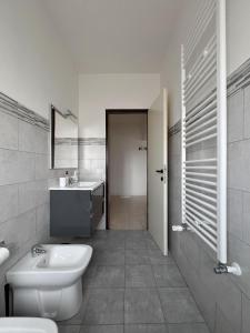 a white bathroom with a sink and a toilet at Atlantico Apartment in Rome