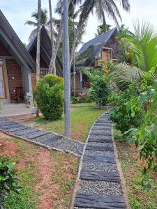 a stone path in front of a house at Steps Garden Resort in Negombo