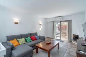 a living room with a blue couch with colorful pillows at Bellavista 1 in Nerja +10 photos