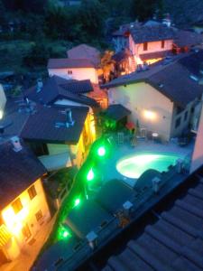 an overhead view of a house with a swimming pool at night at Hotel Azalea in Baveno