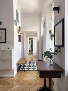 a living room with a table and a hallway at NICE "TRABI" APARTMENT IN THE CITY in Budapest
