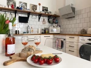 a kitchen with a plate of food and two glasses of wine at NICE "TRABI" APARTMENT IN THE CITY in Budapest