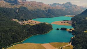 an aerial view of a lake in the mountains at Grand Hotel des Bains Kempinski in St. Moritz