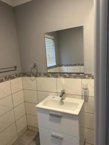 a bathroom with a sink and a mirror at Grandview adventure and guesthouse in East London