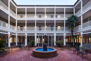 a courtyard with a fountain in the middle of a building at St James Hotel Selma Tapestry Collection by Hilton in Selma