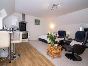 a living room with a bed and a couch and a table at Studio Apartment ideal for short or long stays in Pershore