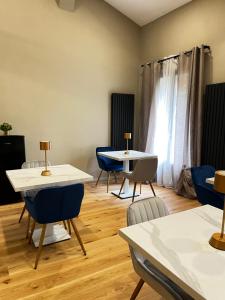 une chambre avec des tables, des chaises et une fenêtre dans l'établissement Affittacamere San Petronio House, à Bologne