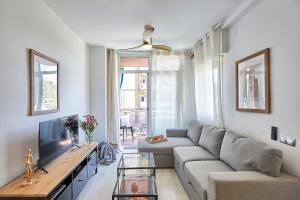 a living room with a couch and a tv at BBarcelona Modern Eixample Flat in Barcelona