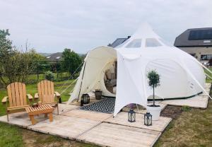 a large tent with two chairs and a table at Glamping -Logie Moonlight in Brakel