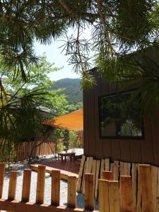 a house with a wooden fence and a picnic table at CampBaseKadojin - Vacation STAY 33535v in Tenkawa