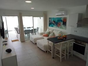 a kitchen and living room with a couch and a table at Nunoli Duplex Luxury Playa Blanca in Playa Blanca