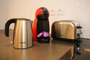 a counter top with a tea kettle and a toaster at Appartement cosy proche université paris 13 - 4P in Paris