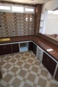 a empty kitchen with a checkered floor in a room at palmerais daglou in Tiznit