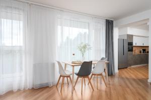 a dining room with a table and chairs at Crystal Apartment in Wrocław