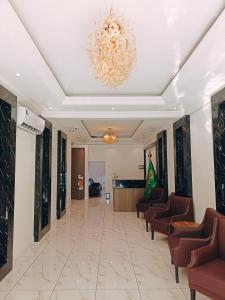 a lobby with chairs and a chandelier at Alhamra Park hotel in Jeddah