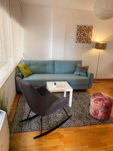 un soggiorno con divano blu e tavolo di Apartments Fontana 20 a Budua