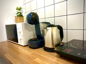 a coffee maker on a counter next to a microwave at ALTiDude in Cluj-Napoca
