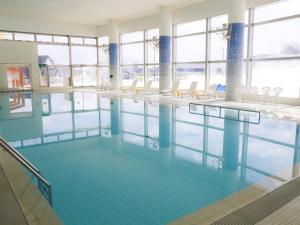 a large swimming pool with chairs in a building at ANA Crowne Plaza Resort Appi Kogen by IHG in Hachimantai