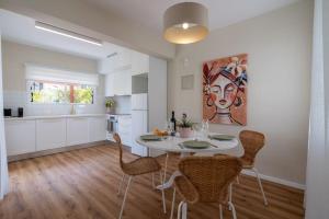 Una cocina y un comedor con mesa y sillas. en Cozy Nerina Cottage at Harbour Paphos, en Pafos 24 fotos más