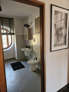 a bathroom with a sink and a toilet at Willa Bimbrówka in Wisła