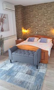 a bedroom with a large bed with a blue bench at Apartment ŠTIZ by the sea with an organized beach in Betina