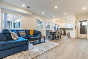 a living room with a blue couch and a table at Periwinkle by AvantStay Walk to Staples Rooftop in Los Angeles