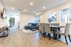 a dining room and living room with a table and chairs at Modern Living by AvantStay DTLA Walk to Staples in Los Angeles