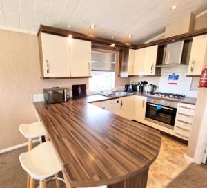 a large kitchen with a wooden counter top at Benarty 11 with Private Hot Tub - Fife - Loch Leven - Lomond Hills - Pet Friendly in Kelty