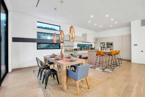 a kitchen and dining room with a table and chairs at LA Villa by AvantStay Walk to The Grove LA in Los Angeles