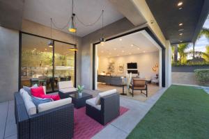 a patio with two couches and a living room at LA Villa by AvantStay Walk to The Grove LA in Los Angeles