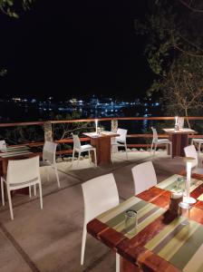 a patio with tables and chairs at night at Tepanee Beach Resort in Malapascua Island