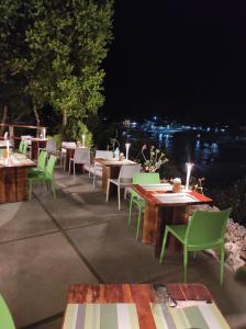 a group of tables and chairs on a patio at night at Tepanee Beach Resort in Malapascua Island