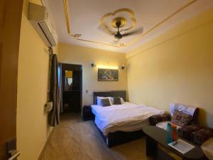 a small room with a bed and a couch at Hotel D S Residency Varanasi in Varanasi